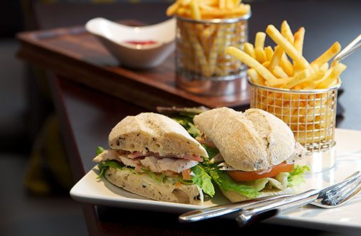 A tasty sandwich and basket of fries